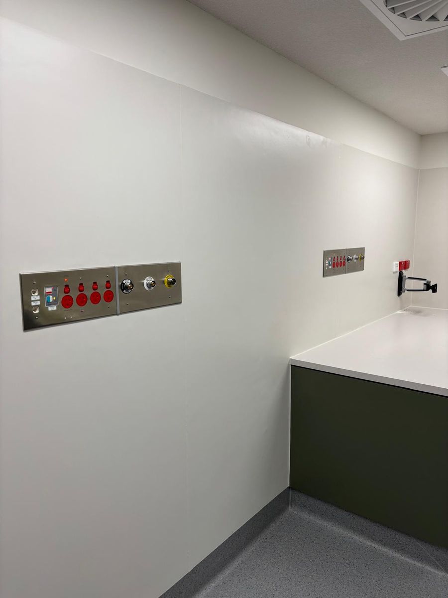 Medical air, oxygen and suction outlets on medical service panels in a treatment room